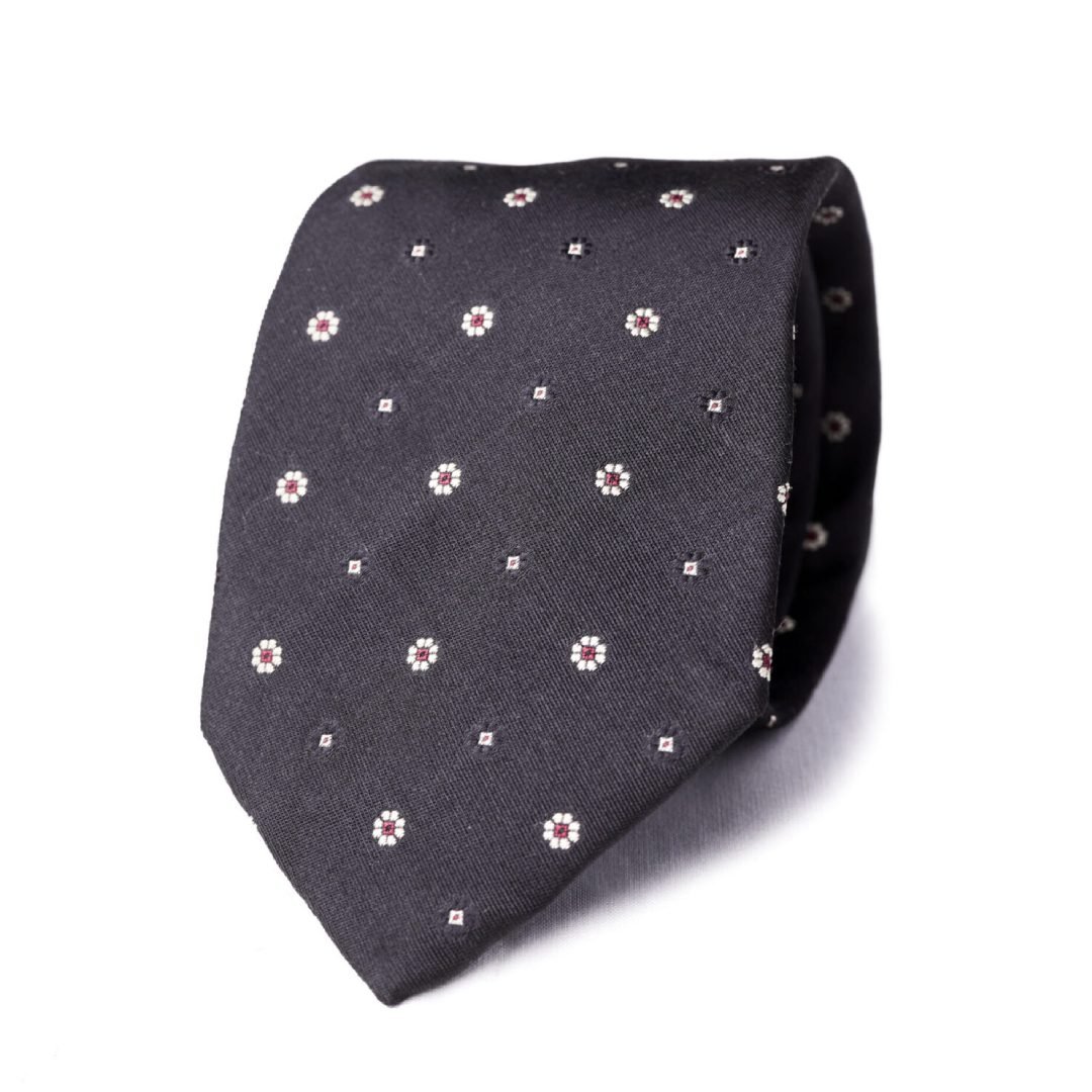 A black tie with white flowers on it