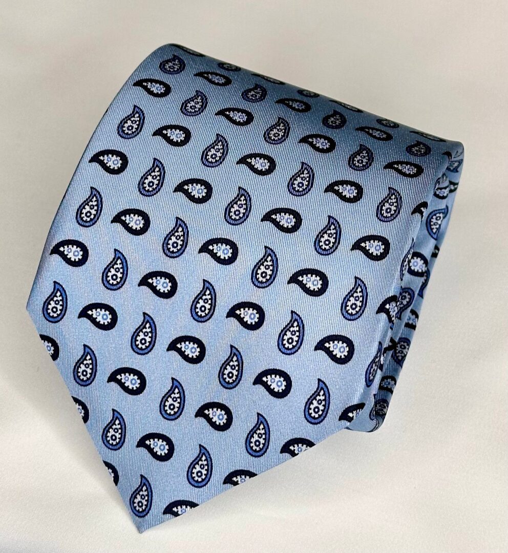 A blue tie with black and white paisley pattern.