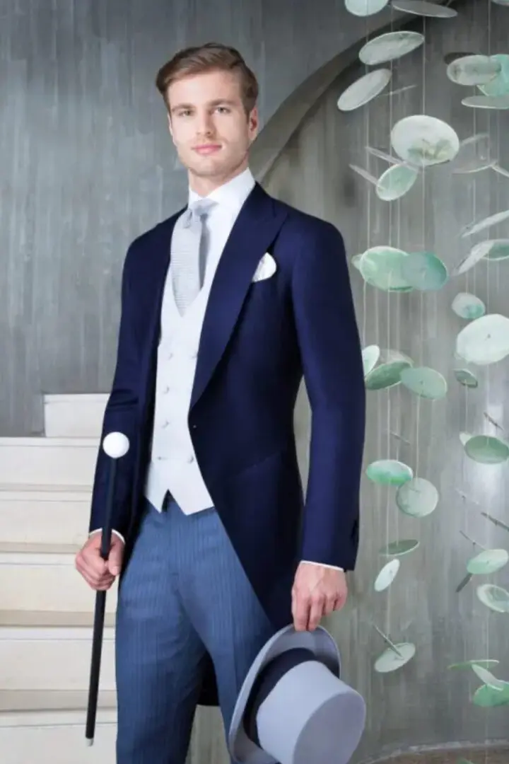 A man in a suit and tie standing on steps.