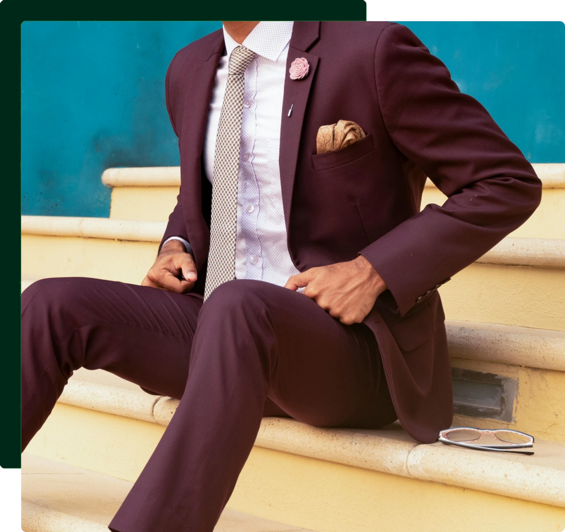 A man in a suit sitting on steps.