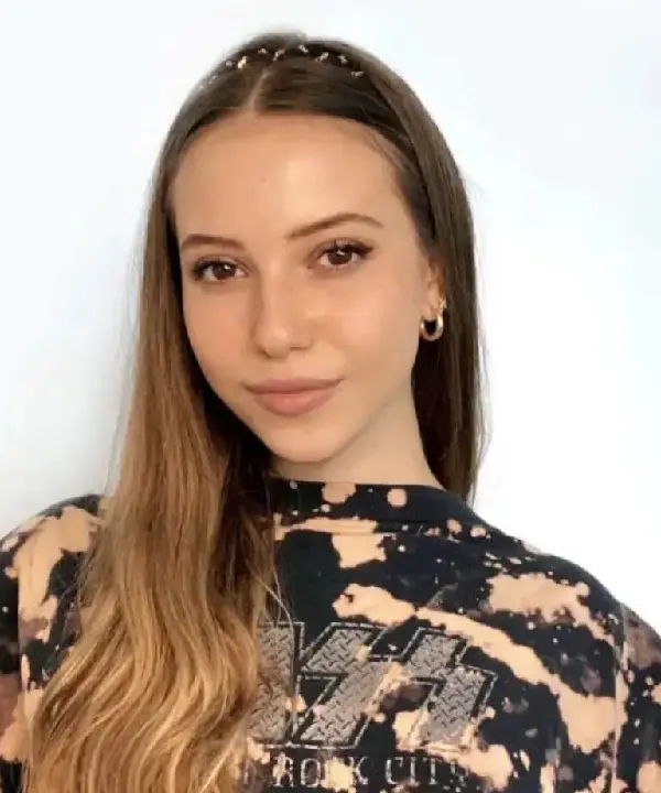 A woman with long hair wearing a black and white shirt.